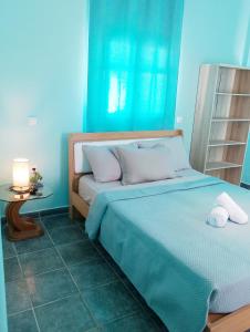a blue bedroom with a bed with two pillows at Prasonisi villas in Karpathos