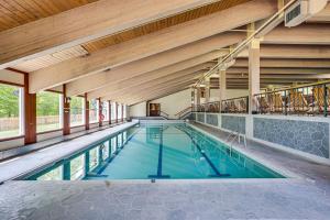 an indoor swimming pool with blue water in a building at Winter Fun! Resort Condo half Mi to Campton Mtn in Campton