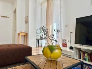 a vase of lemons on a table in a living room at Metro Suites in Tirana