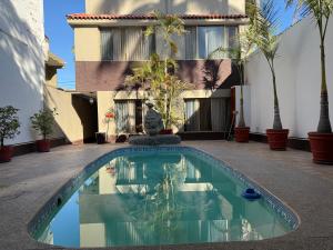 a swimming pool in front of a building at Villa Texcalame in Lo de Marcos