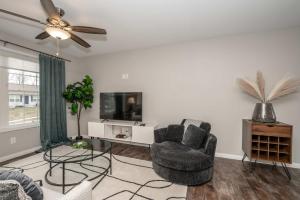 a living room with a chair and a tv at The Gem Vacation Rental in Walton