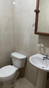 a bathroom with a toilet and a sink at Villa Texcalame in Lo de Marcos