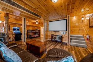 een woonkamer met een groot scherm in een hut bij Blackjack Holiday home in Gatlinburg