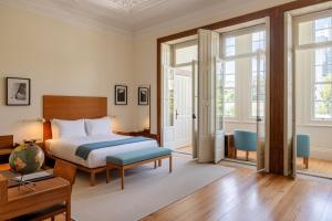 a bedroom with a bed and a table at Casa do Arquiteto Townhouse - Adults Only in Porto