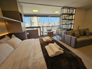 a bedroom with a large bed with towels on it at Studio Tatuapé - SP in São Paulo +288 photos