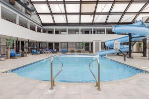 a pool with a slide in a large building at Best Western Rochester Hotel Mayo Clinic Area/ St. Mary's in Rochester