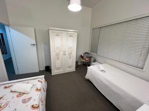 a bedroom with two beds and a window at Mount Eden Park in Auckland