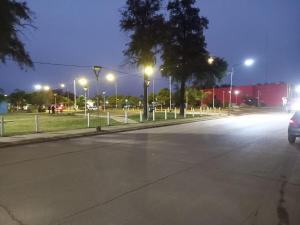 an empty street at night with street lights at El Amanecer 7 12 in Charata