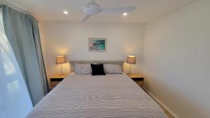 a bedroom with a large bed with two lamps at Buena Vista in Guilderton