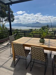 a wooden table and chairs on a patio at La Dolce Vita, Guatavita in Guasca