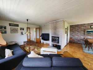 a living room with a blue couch and a fireplace at Casa blanca in Kosta +6 photos
