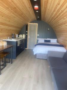 a large bedroom with a bed and a kitchen at Fallagh Fort Escapes in Rousky