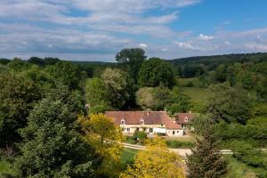 an aerial view of a house in the woods at Séjour au Moulin de Boiscorde, Le Perche in Rémalard