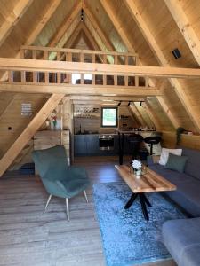 a living room with a couch and a table at Vila Jezero-Jajce in Jezero