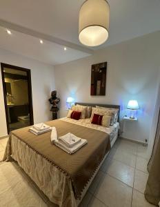 a bedroom with a large bed with two towels on it at Luxury Living SKG 2 in Thessaloniki