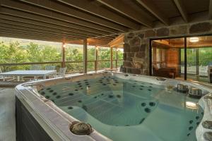 a large jacuzzi tub in a house with a view at How Sweet It Is in Pittman Center