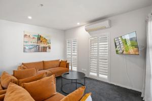a living room with a couch and a table at Cecil Peak View Apartment in Queenstown