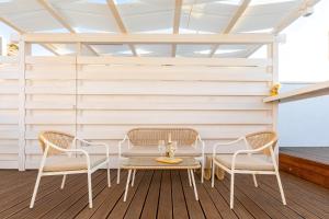 a patio with two chairs and a table on a deck at Schinosa 30 luxury room in Bisceglie