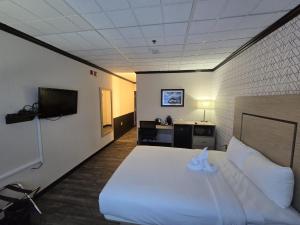 a hotel room with a bed and a television at Sternwheeler Hotel & Conference Centre, Trademark by Wyndham in Whitehorse