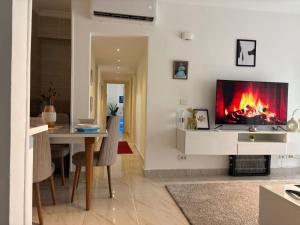 a living room with a fireplace and a dining table at VIP B43 Stunning New Apartment in Madinaty in Madinaty