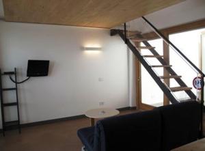 a living room with a staircase and a couch at Caselli Vigole al Sole in Toscolano Maderno