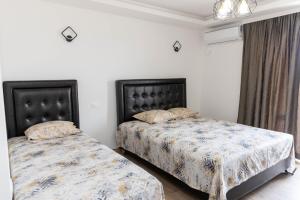 two beds sitting next to each other in a bedroom at Apartments Ceka in Ulcinj