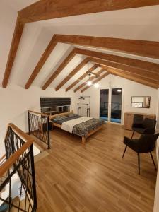 a bedroom with a bed in a room with wooden floors at Villa Marija in Livno