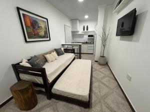 a bedroom with a bed and a couch in a room at Don Antonio Apart 1 in Resistencia