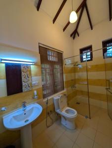 a bathroom with a toilet and a sink at Airport Blessings Villa in Katunayaka +75 photos