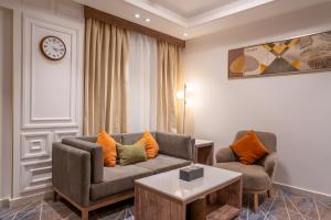 a living room with a couch and two chairs at Nars Plus Al Naeem Hotel in Jeddah