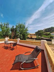 a chair and a table on a patio at Villa Nevada - Espacioso Chalet con Piscina Privada y Salita de Cine in Port de Pollensa