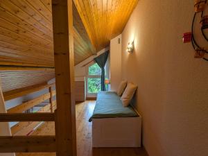 a hallway with a bench in a room with a wooden ceiling at Chalet chaleureux à Gérardmer, vue pistes, 4 pers. - FR-1-589-371 in Gérardmer +27 photos