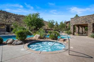 a hot tub in the middle of a yard at Sierra Sky - Patio with fireplace in Hurricane