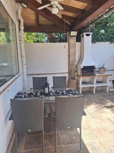 a table and chairs on a patio with a stove at Villa Nevada - Espacioso Chalet con Piscina Privada y Salita de Cine in Port de Pollensa