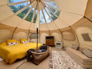 a bedroom with a bed in a tent at Les Hulottes in Le Vrétot