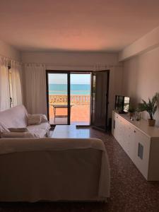 a bedroom with a bed and a view of the ocean at Atico la piramide en primera 1º línea de mar in Vinarós