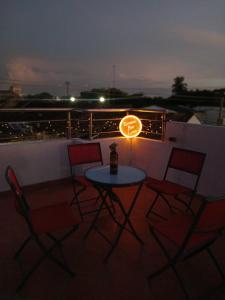 a table with a light on top of a balcony at Hotel Isla Capri in Mompos