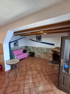 a living room with a pink couch and a table at Seaside secluded apartments Cove Virak, Hvar - 4035 in Gdinj