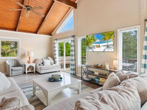 a living room with two couches and a table at 1662 - Dune Our Thing in Corolla