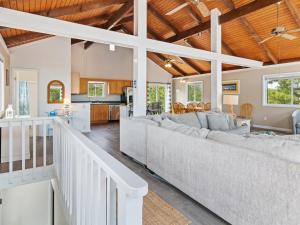 a living room and kitchen with a large couch at 1662 - Dune Our Thing in Corolla +49 photos