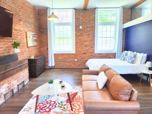 a living room with a couch and a bed at Jennifer's Historic Downtown Loft in Providence