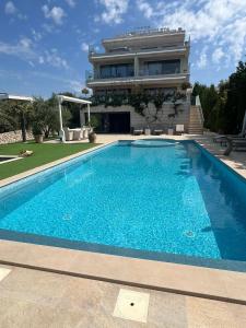 a swimming pool in front of a building at Family-friendly apartments with swimming pool Mandre, Pag - 24502 in Kolan +10 photos