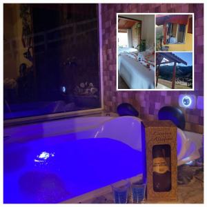 a bathroom with a blue tub with a bottle of wine at Chalé monte verde com hidromassagem in Camanducaia
