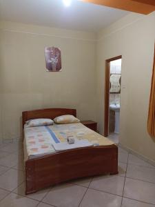 En eller flere senge i et værelse på Hospedaje Momentos