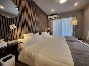 Ένα ή περισσότερα κρεβάτια σε δωμάτιο στο GuestHouseAQUA101