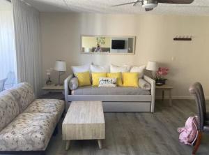 a living room with a couch and a table at Lovely APT AC, Free Parking, Ocean View in Honolulu