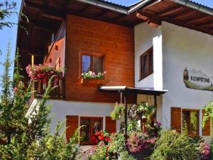 a house with flower boxes on the windows at Apartment in Hüttau near Ski Amadé Slopes in Hüttau +6 photos