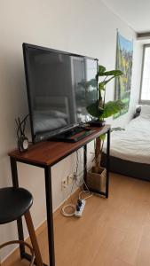 a large television on a table in a bedroom at Kozy House in Gangnam in Seoul