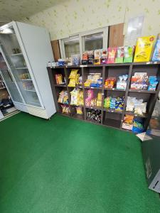 a store with a green floor and shelves of food at Jeryeong Forest Pension in Gapyeong