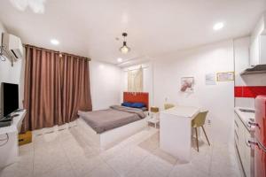 a bedroom with a bed and a desk in it at Jeryeong Forest Pension in Gapyeong